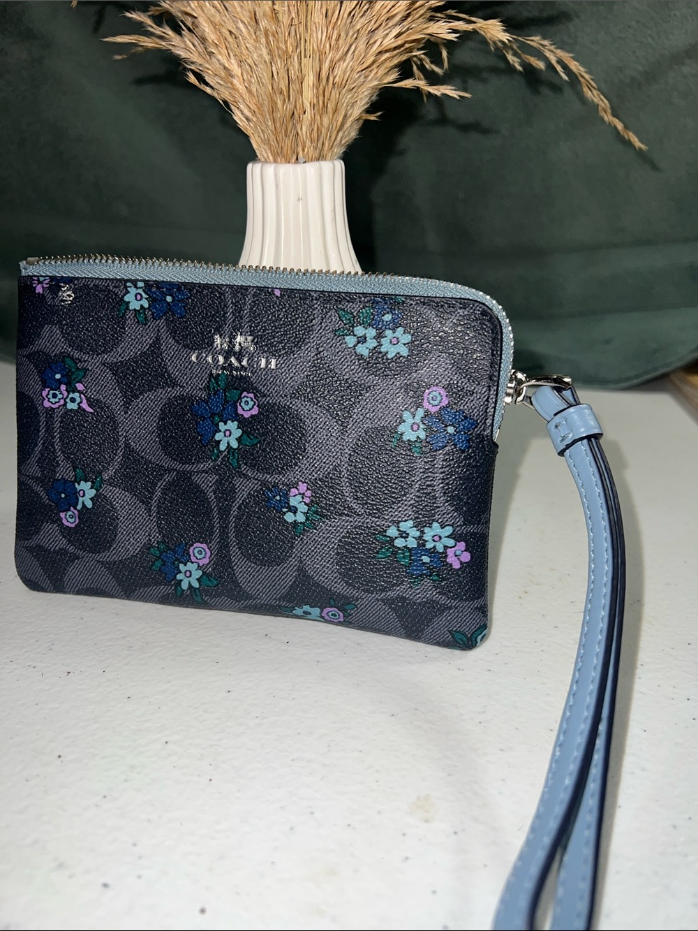 Coach Signature C Ranch Floral Large Wristlet featuring a dark floral design.
